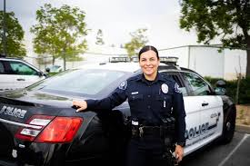 Officer leaning on her car