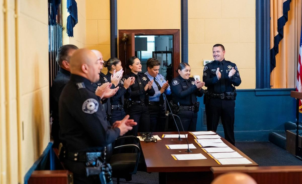 Officers applauding a colleague