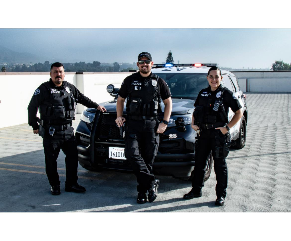 Officers standing in front of vehicle